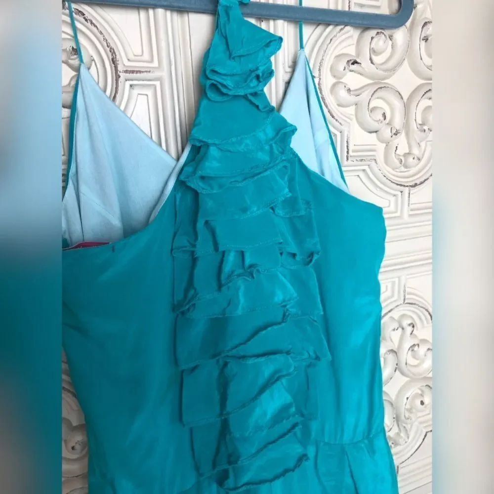 Turquoise wink romper with ruffle details size small